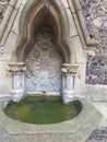 Church fountain full of green water ancient stones surround it Royalty Free Stock Photo