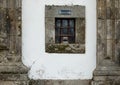 Church front facade with small window for donation or alms