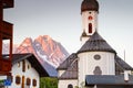 Church in Garmisch with Zugspitze peak in red morning sunlight Royalty Free Stock Photo