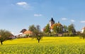 Church and golden rapeseed field (brassica napus)