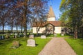 Church with gravestones on a spring day Royalty Free Stock Photo