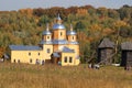 Church and group of old wooden windmills standing on the meadow.