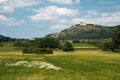 Church on hill over village field scene