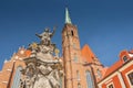 Church of the Holy Cross and St Bartholomew and statue of John of Nepomuk in Wroclaw, Poland.