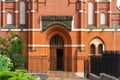 Church of Holy Family. Magnificent Catholic church of early 20th century. Fragment of building. Close-up of entrance to concert Royalty Free Stock Photo