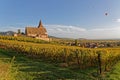 Church of of Hunawihr, vineyards, and balloons in the sky Royalty Free Stock Photo