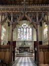 Church interior with carved wooden structure and stained glass windows Royalty Free Stock Photo