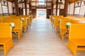 Church interior with empty wooden pews.