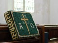 Church kneeler on wooden pew, for Christian prayer. Royalty Free Stock Photo