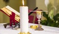 Lit candle illuminates chalice with wine and ciborium with the host, ready for the communion of the faithful Royalty Free Stock Photo