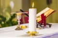 Lit candle illuminates chalice with wine and ciborium with the host, ready for the communion of the faithful Royalty Free Stock Photo