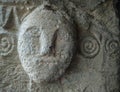 Sardinia. Mogoro. Church of the Madonna del Carmine, 14th century. Human protome carved in the left jamb of the main facade door Royalty Free Stock Photo