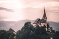 the Church of Maria Woerth at lake woerthersee at sunrise