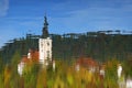 The Church of Mary the Queen mirrored in the water of Lake Bled in autumn.