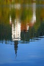 The Church of Mary the Queen mirrored in the water of Lake Bled in autumn.