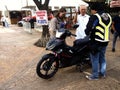 A church minister blesses a new motorcycle and its owners