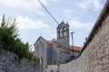 Church and Monastery of St. Francis, with stone walls on both sides and the sky at the background, in Pula, Croatia