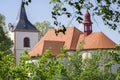 Church named Nanebevzeti panny Marie in Vraclav village, sacral historic heritage with tower nad red roof on the hill, blue sky