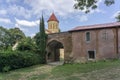 Church of the Nativity of the Mother of God of Betania monastery. Entrance to the monastery. Brick arch, church dome with a cross Royalty Free Stock Photo