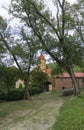 Church of the Nativity of the Mother of God of Betania monastery. Road to the monastery. Brick arch, church dome with a cross. Royalty Free Stock Photo