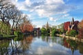 Church on the other side of the lake. Blue sky and blue water on spring day, with reflection in the water. Beautiful colorful land Royalty Free Stock Photo