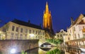 Church of Our Lady and canal illuminated in the night. Bruges, Belgium Royalty Free Stock Photo