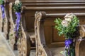 Church pew details with floral wedding decoration Royalty Free Stock Photo