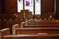 Church Pews with Stained Glass Beyond Pulpit Royalty Free Stock Photo