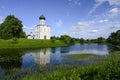 The church of Pokrova-na-Nerli and its reflection in the river among trees and meadows in Bogolyubovo, Russia Royalty Free Stock Photo