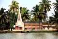 Palm trees and teh river bank church