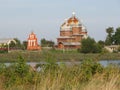 Church on the river bank, country wood church, ukrainian, meadow outfield grass lea graze there is a grove behind
