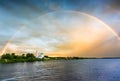 church on river bank and rainbow after rain Royalty Free Stock Photo