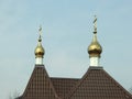 Church roof with golden cupola and crosses on the sky background