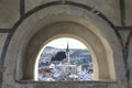 Church and roofs thru window in wall in Cesky Krumlov Royalty Free Stock Photo