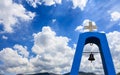 Church`s steeple in Greece. Cross on top and bell. Clouds on blue sky background, copyspace Royalty Free Stock Photo