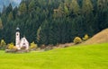 The church of Saint John, Ranui, Chiesetta di san giovanni in Ranui Runes South Tyrol Italy, surrounded by green meadow, forest Royalty Free Stock Photo