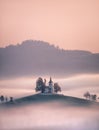 Church of Saint Tomas, Slovenia emerging from fog Royalty Free Stock Photo