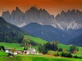 The church Santa Maddalena with the impressive Odle Mountains Group in the background at sunset. Royalty Free Stock Photo