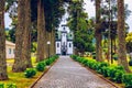 Church of Sao Nicolau (Saint Nicolas) with an alley of tall trees and hydrangea flowers in Sete cidades on Sao Miguel island, Royalty Free Stock Photo