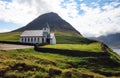 Church by the sea with ocean and mountain panorama, Vidareidi, Faroe Islands, Denmark, Northern Europe Royalty Free Stock Photo
