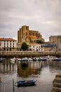 Church on the shore of a pier with boats on the water