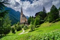 A church sits amongst mountainous terrain in Heiligenblut, Austria