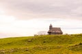 Church in the Slovenia big plateau pasture Velika Planina. Chapel on the hill, religion symbol.Dramatic mystic clouds and colors