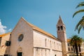 Church of St. Dominic with palm tree in Trogir, Croatia Royalty Free Stock Photo