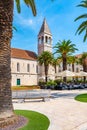 The Church of St Dominic, Trogir - Croatia. Beautiful view of ancient building, palm trees and the restaurant near. Summer weather Royalty Free Stock Photo