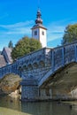 Church of St. John the Baptist and a bridge by the Bohinj lake, Slovenia Royalty Free Stock Photo