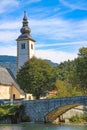 Church of St. John the Baptist and a bridge by the Bohinj lake, Slovenia Royalty Free Stock Photo