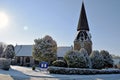 A snowy winter scene of a Church and church yard all cover in white snow