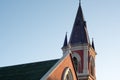 A church steeple against a clear blue sky at sunset