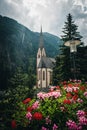 Church with steeple amidst mountains and flowers Royalty Free Stock Photo
